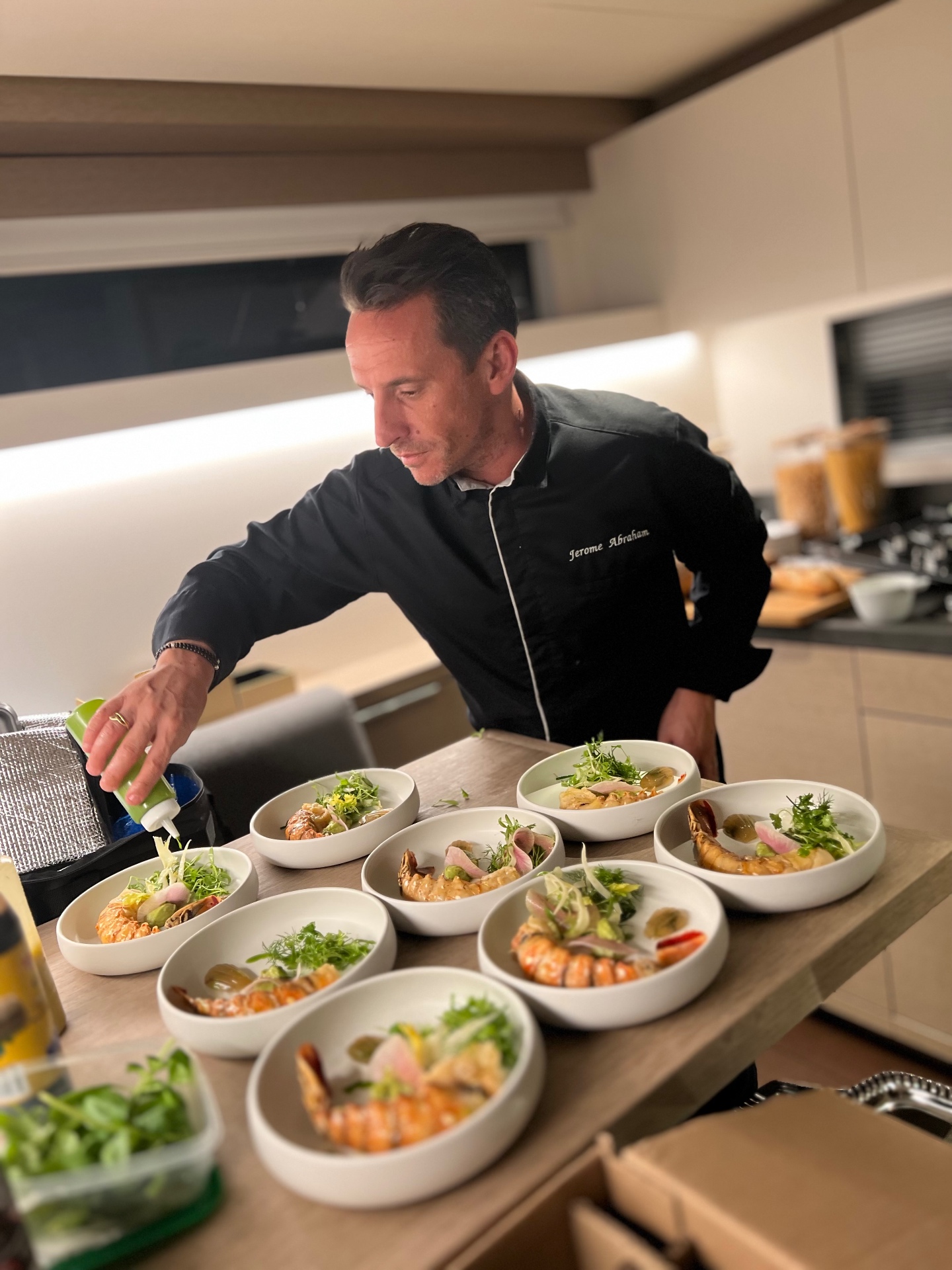 Private Chef Miami Jérôme Abraham plating dishes in a kitchen